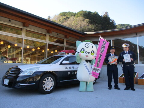 パトカーの前で佐川署員と写真を撮るまきにゃん